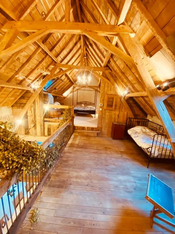 an attic room with two bunk beds in it at Duo La belle échappée & Romance in Poperinge
