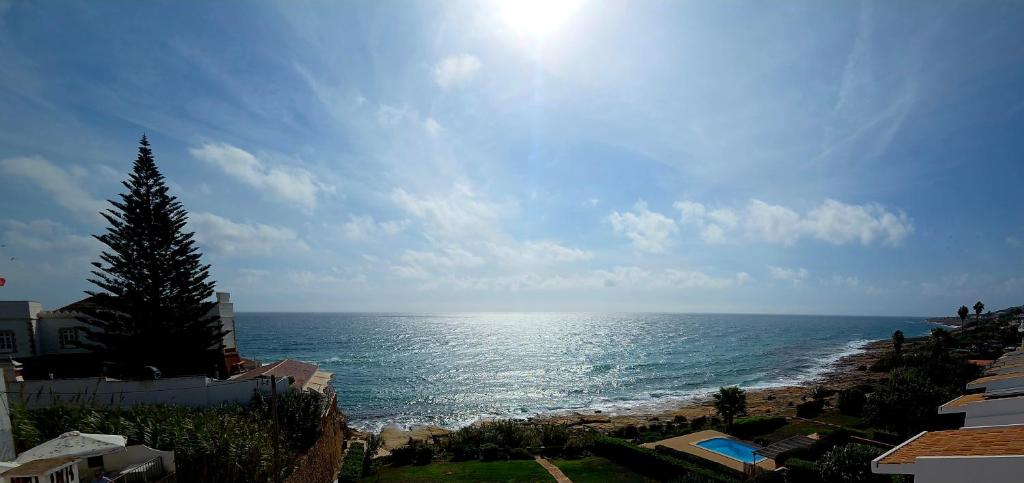 a view of the ocean on a sunny day at Casa Prainha da Luz in Luz