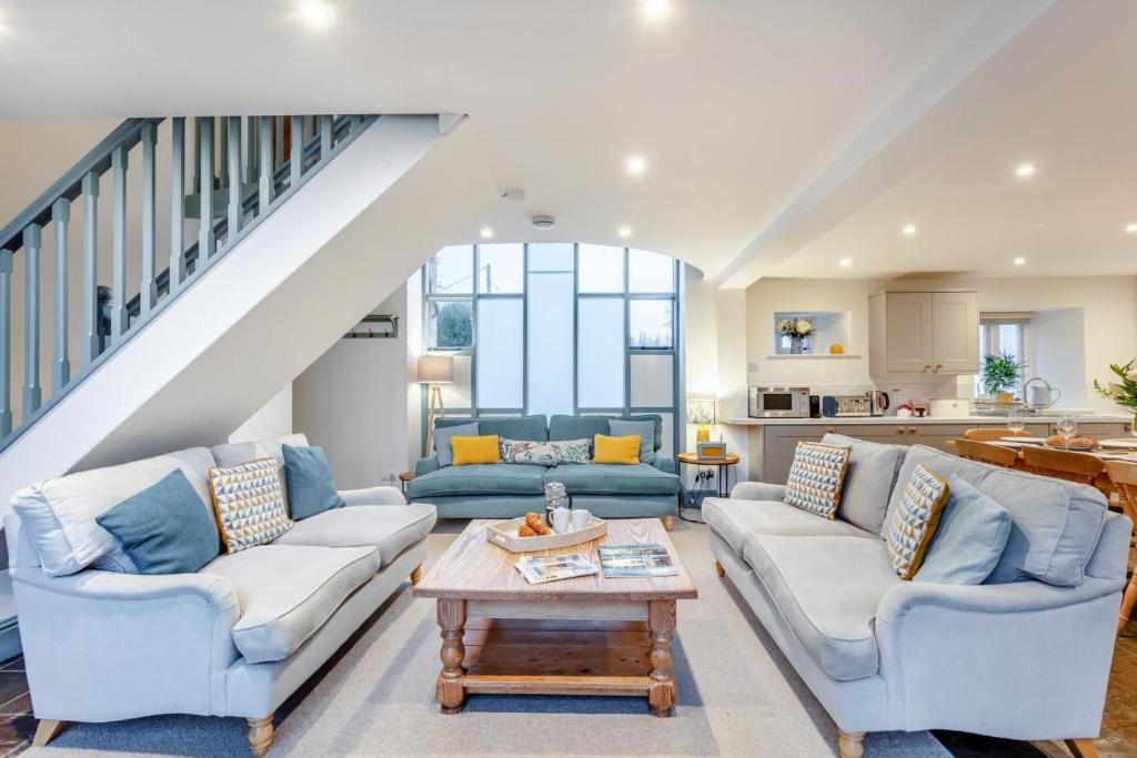 a living room with two couches and a table at 4 Bed in Shebbear oc-w33730 in Black Torrington