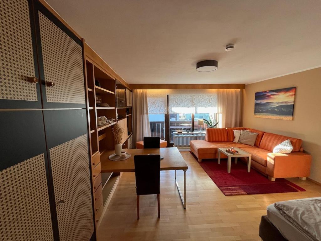 a living room with a couch and a table at Cozy Apartment in Inzell in Inzell
