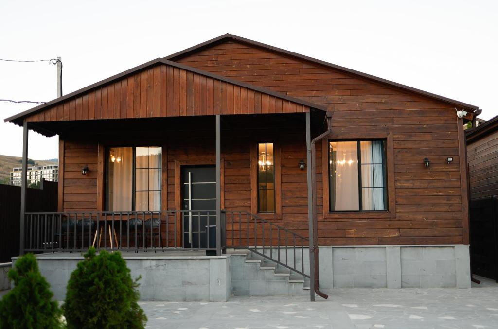 a wooden house with a porch and a balcony at Dili Hill in Dilijan