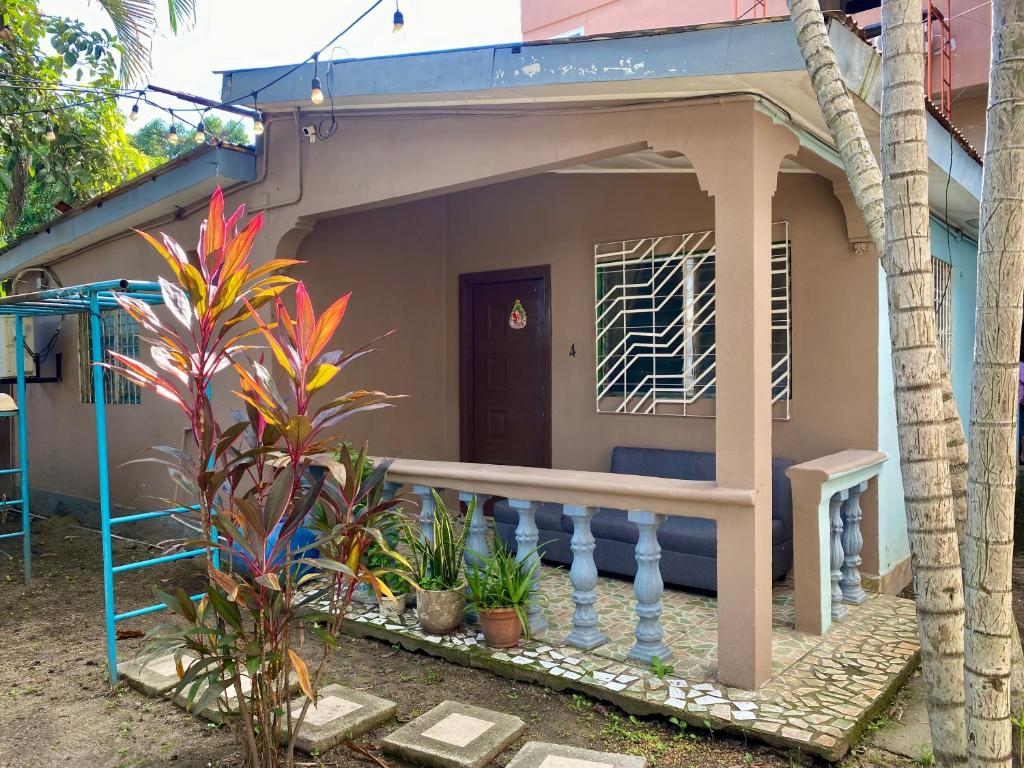 a small house with a bench in front of it at La Casita in San Pedro Sula