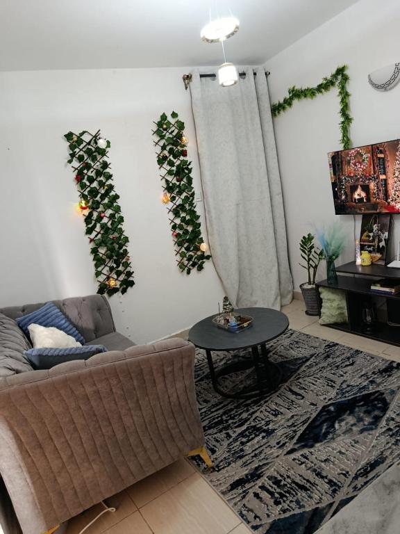 a living room with a couch and a table at EnkishoniBnB Kitengela in Nairobi