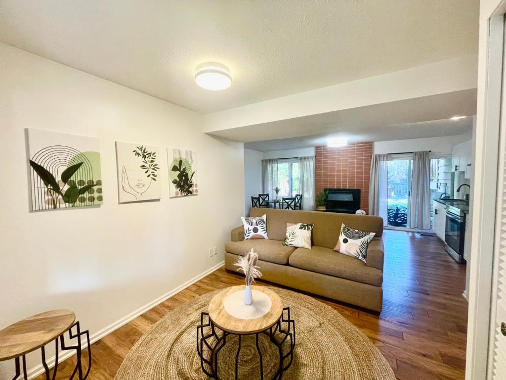 a living room with a couch and a table at Charming Central Abbotsford Retreat, Cozy Suite in Abbotsford
