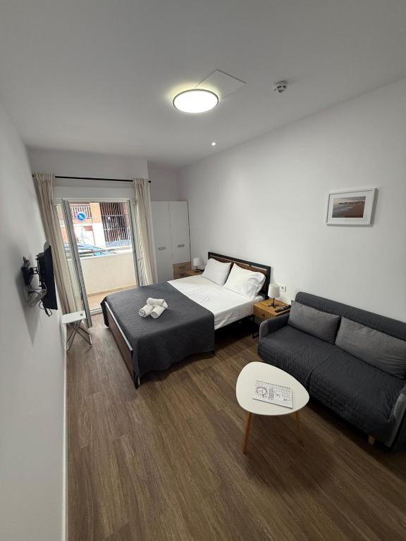 a living room with a bed and a couch at HS Beach in Torrevieja