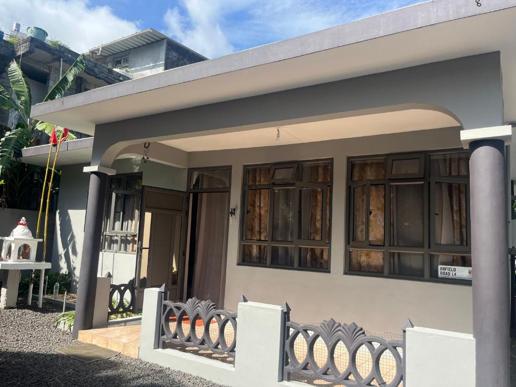 a building with large windows on the side of it at House Raghu in Rose Belle