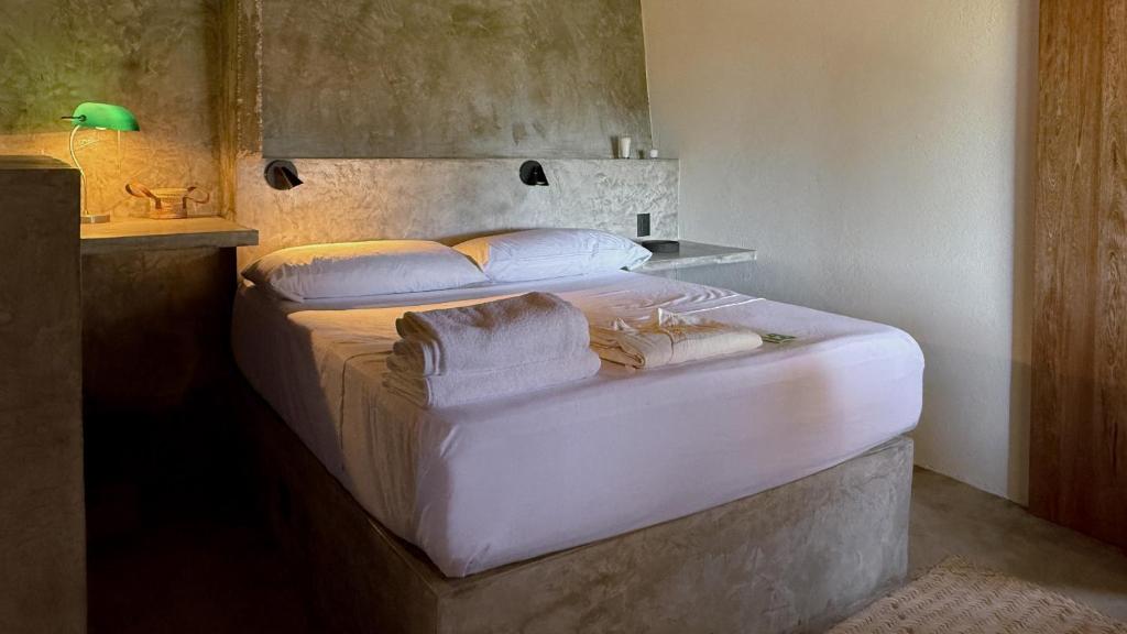 a bedroom with two beds with towels on them at Lalito in Zipolite