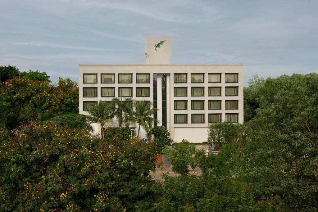 a large white building with trees in front of it at The Fern Residency Ahmedabad, Subhash Bridge, Series by Marriott in Ahmedabad