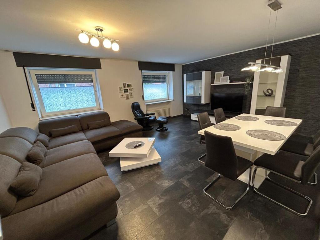 a living room with a couch and a table at Perfect for longer stays in Heinsberg