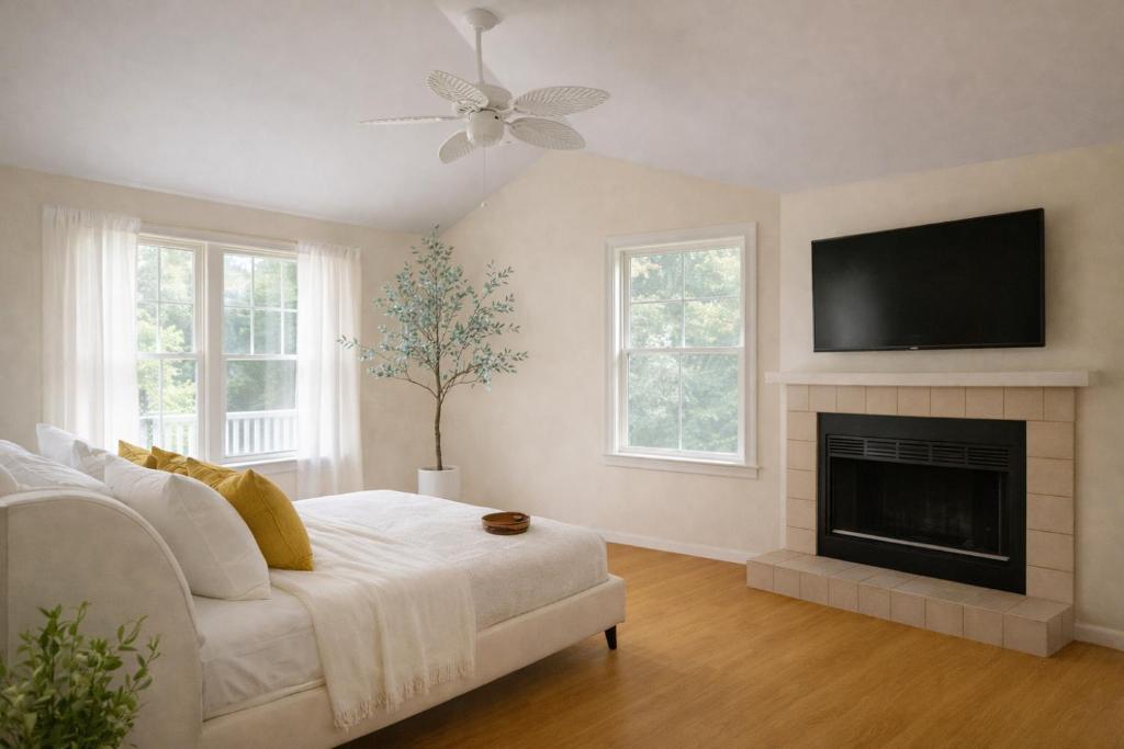 a living room with a white couch and a fireplace at Coastal Chateau Cottages in Ocean City