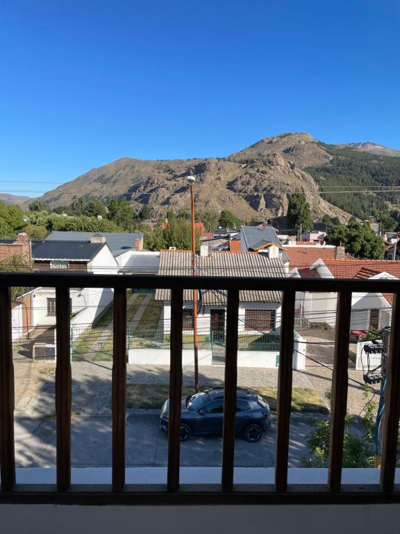 a balcony with a car parked in a parking lot at Rosa Mosqueta Esquel in Esquel