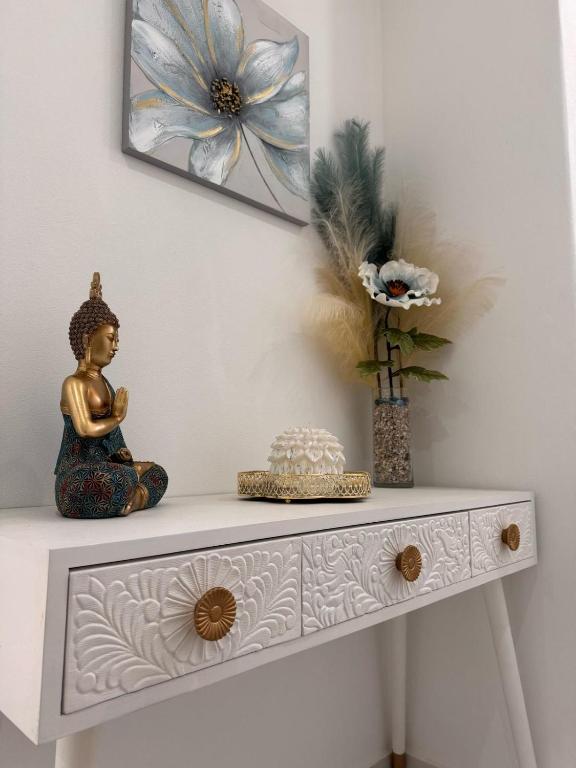 a white table with a statue on top of it at Casa Ventura in Lagos
