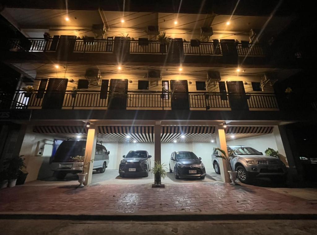 a building with cars parked in a parking lot at night at Studio Apartment in Mactan, Cebu Room304 in Lapu Lapu City