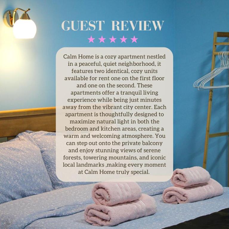 a sign with towels on a bed with a guest review at Calm Home Apartment in Mestia