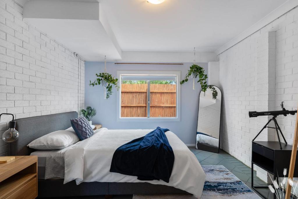a bedroom with a bed and a window at Kangaroo Sanctuary Studio in Sanctuary Point