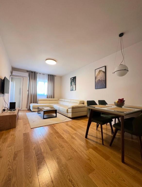 a living room with a couch and a table at White Homes 1BR - Central Point in Podgorica