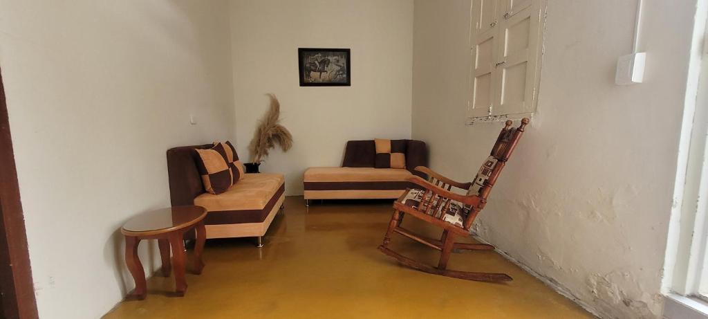 a living room with a chair and a couch at La Ermita apto in Roldanillo