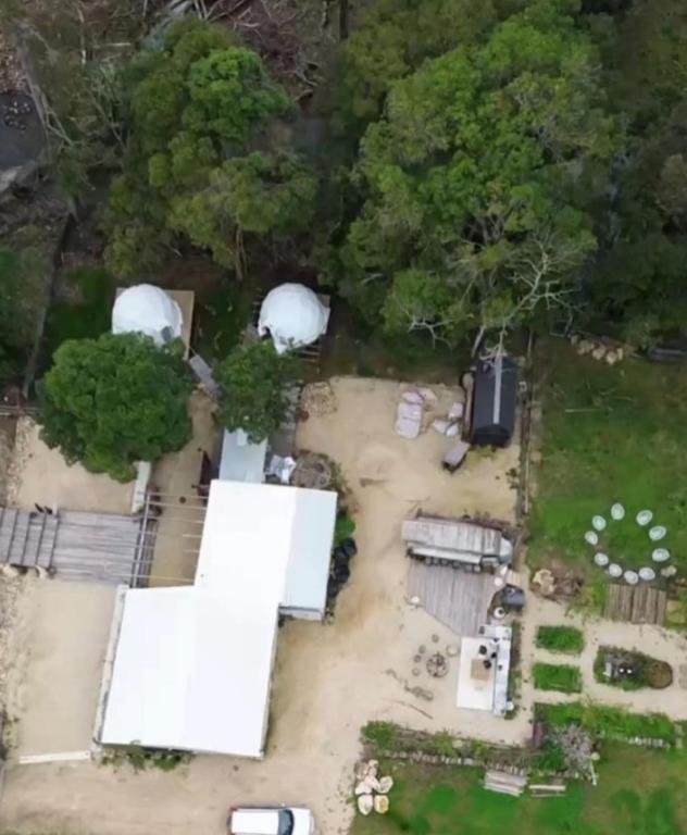 an aerial view of a yard with white domes at Nature Domes in Comboyne