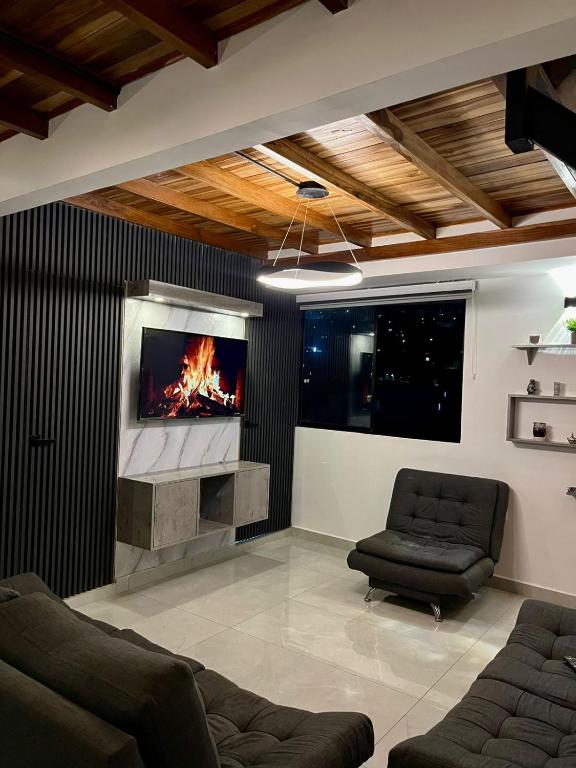 a living room with a fireplace and a tv at Apto Domus in Pamplona