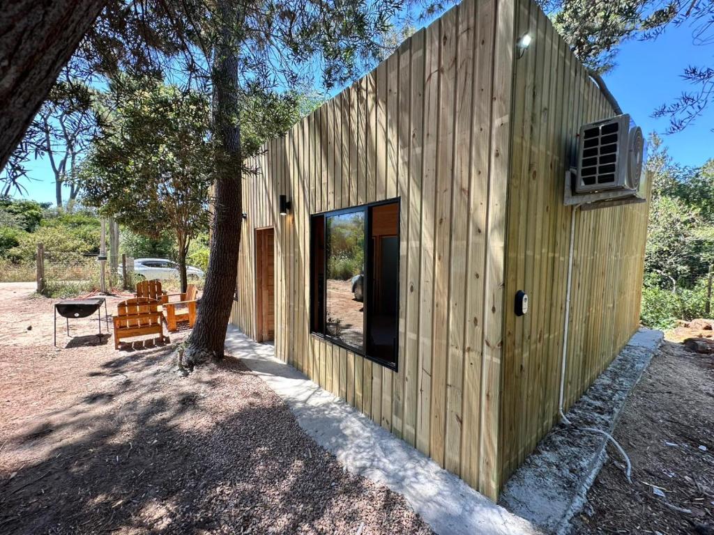 a wooden house with a tree in front of it at Refugio del Mar 3 in Ocean Park