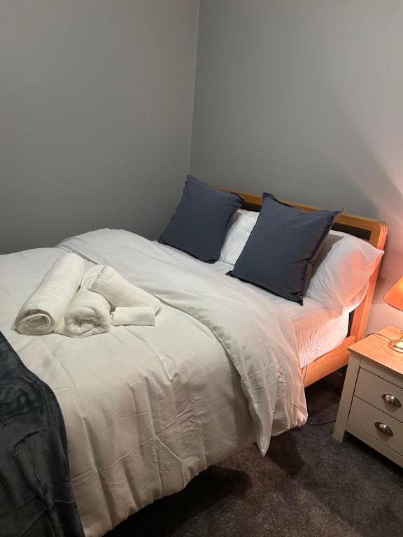a bedroom with a bed with two pillows at Lancing in Lancing