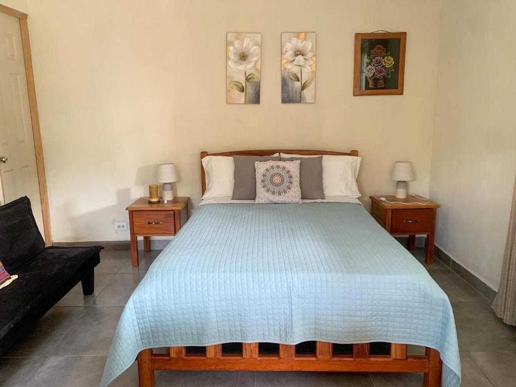 a bedroom with a large bed with two night stands at Venus Lodging House in Alto Boquete