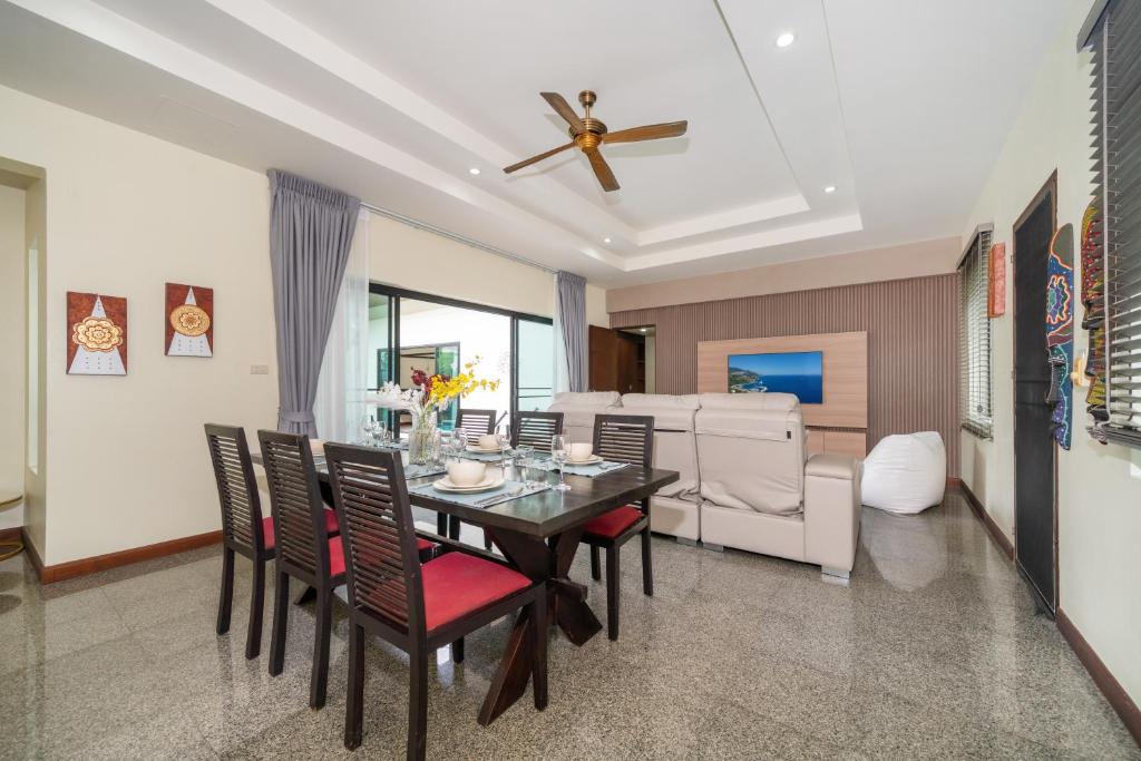a dining room with a table and chairs at Rawai - 3 BR Private Pool Villa - Phoomjai Villa in Rawai Beach
