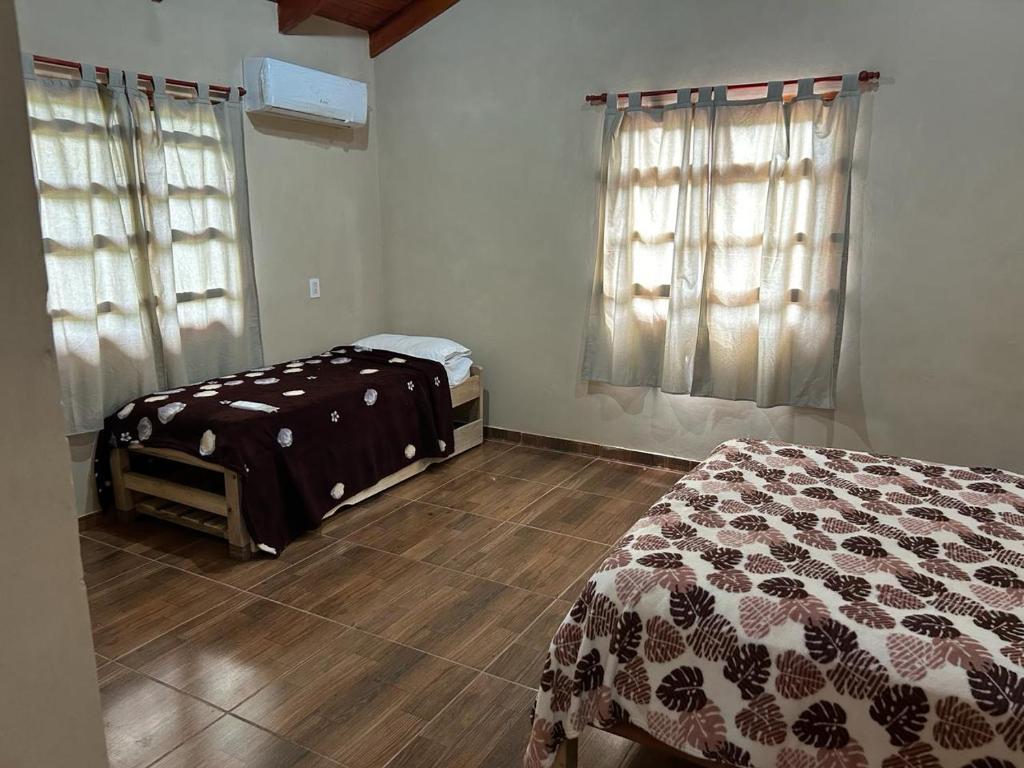 a bedroom with a bed and a wooden floor at Cabañas la flor 