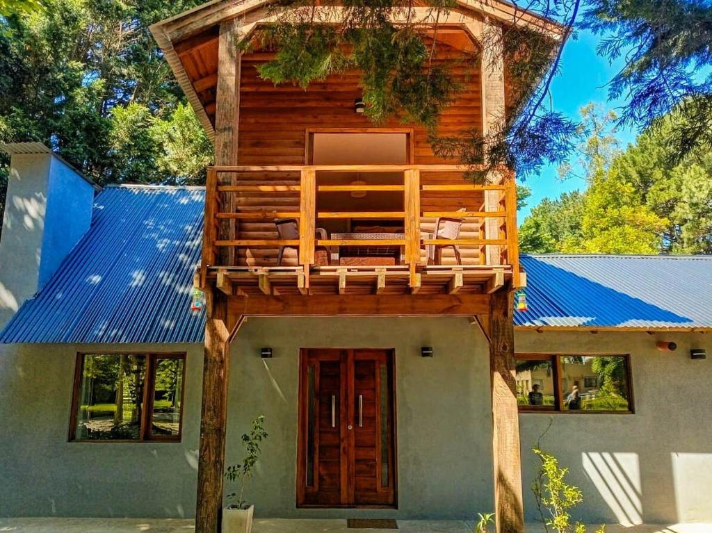 a tree house with a deck on top of it at Casa Cabaña Los Zorzales Santa Clara del Mar-Argentina in Santa Clara del Mar