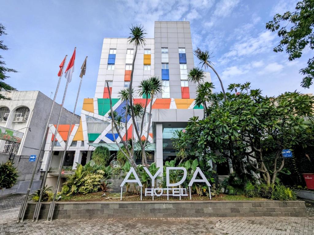 a building with a sign in front of it at Ayda Mangga Dua ex Zuri Express Mangga Dua in Jakarta
