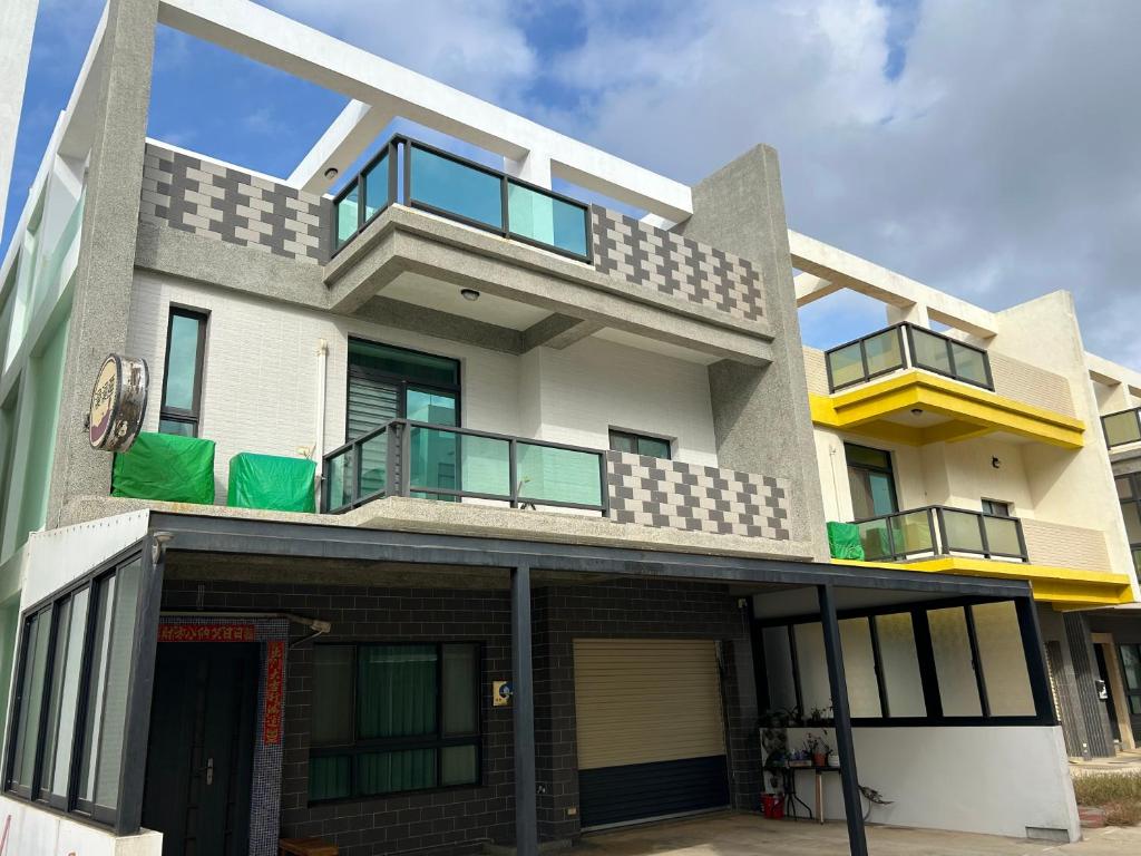 a large house with a balcony on top of it at Shower & Sleep in Huxi