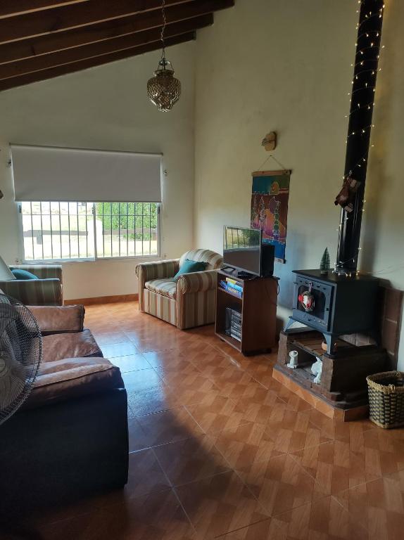 a living room with a couch and a tv at el maiten in Mar del Plata