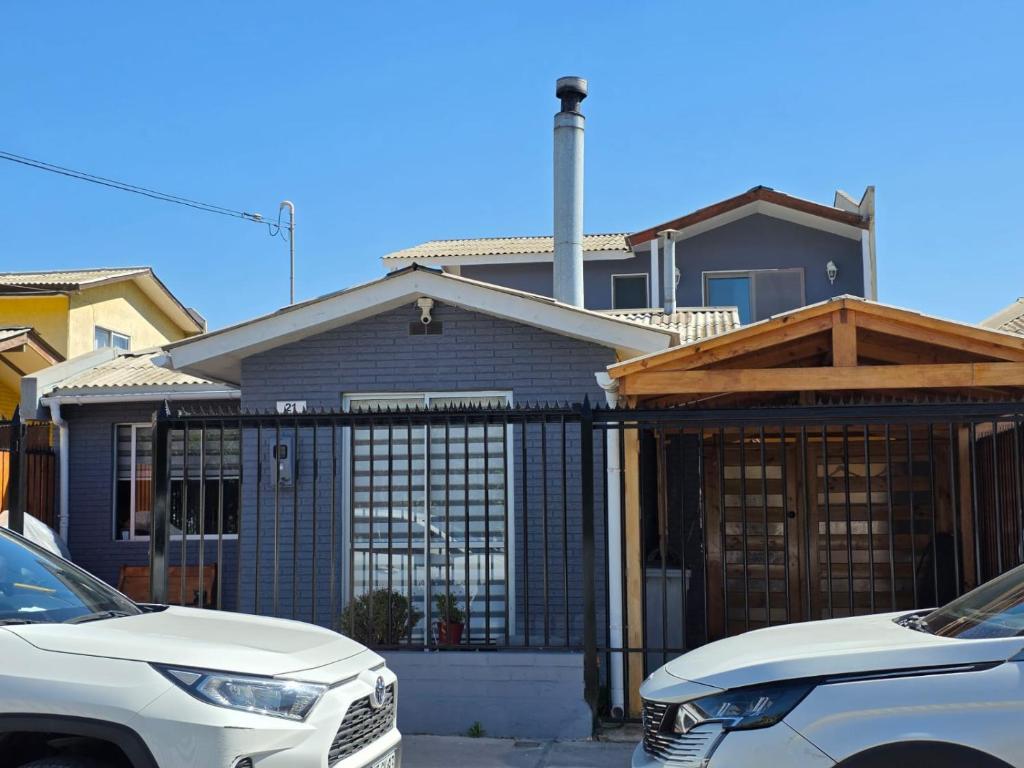 a white car parked in front of a house at Casa Flor del aire in La Serena