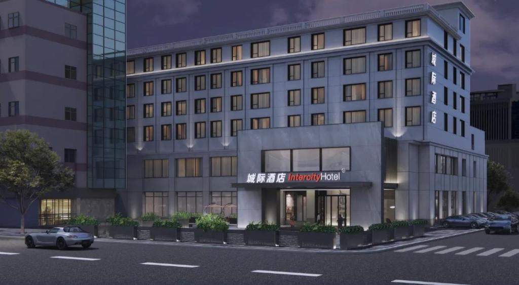 a rendering of a building with a car parked in front at Nantong Haohe Intercity in Nantong