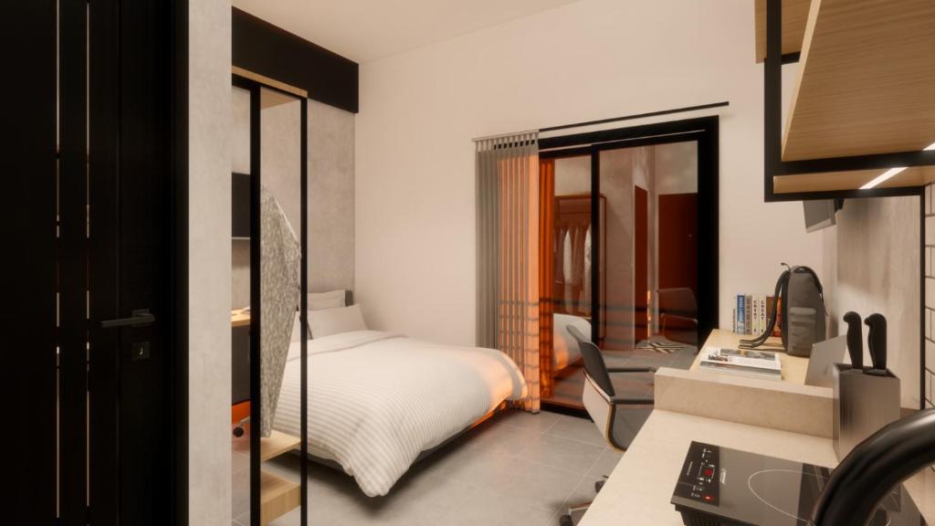 a hotel room with a bed and a desk at Voyager Residence in Semarang