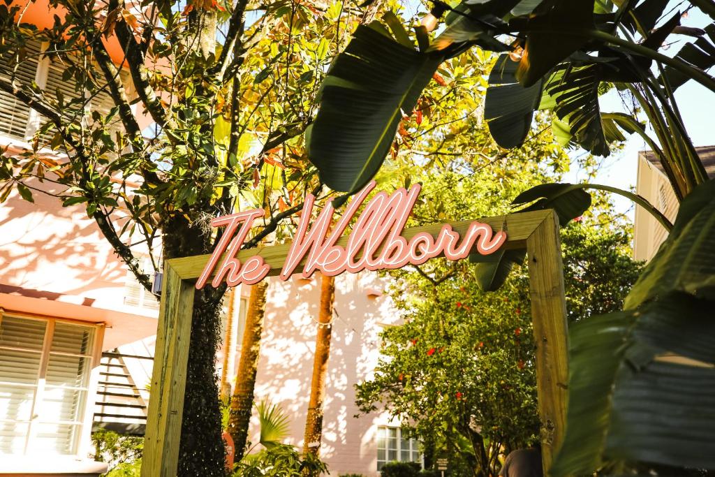 a sign that says the illusion in front of a house at Suites by The Wellborn in Orlando