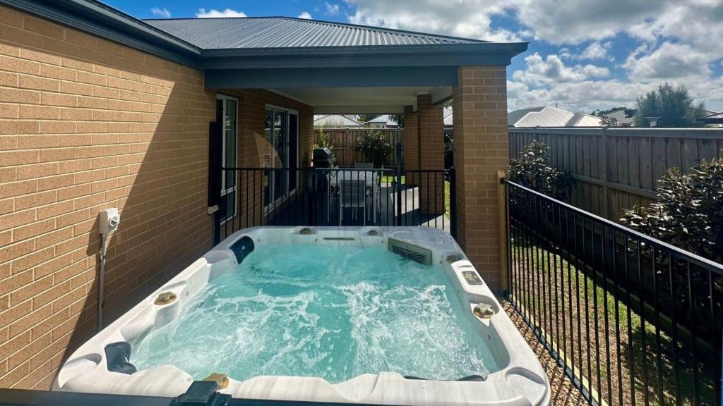 a hot tub on the side of a house at Salt Breeze in Cowes