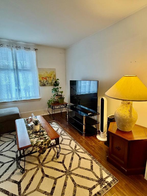 a living room with a couch and a television at Cozy Full House 3 bedrooms in Regina