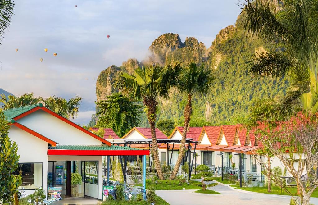 a row of houses in front of a mountain at Ruby Mountain View Resort Vang-vieng in Vang Vieng