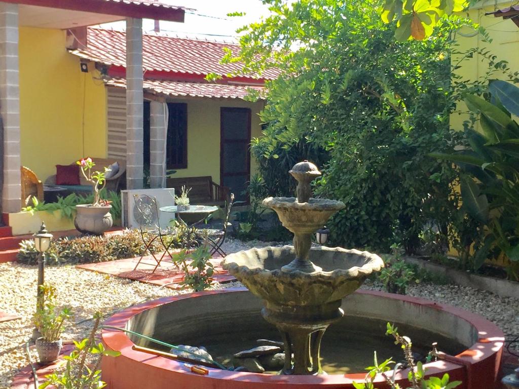 a fountain in the middle of a garden at Dili Central Stay Apartment 60mts2 in Dili
