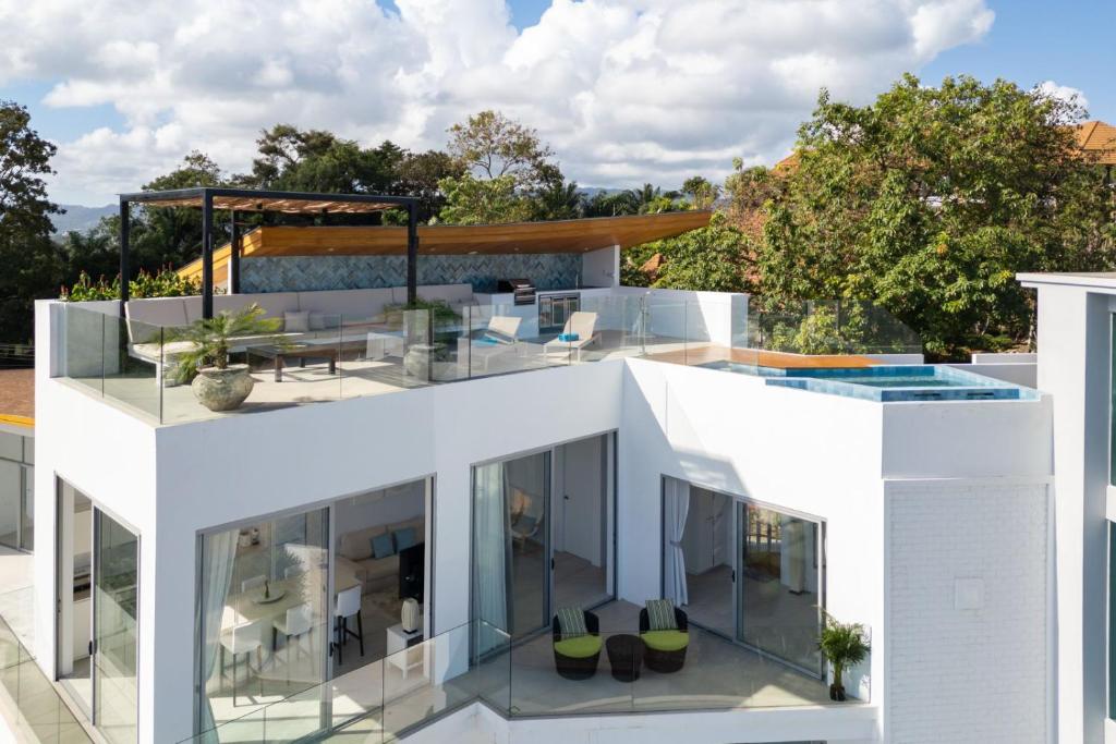 a white house with a pool on top of it at Penthouse Residence 8 Suite 2 in Nathon Bay