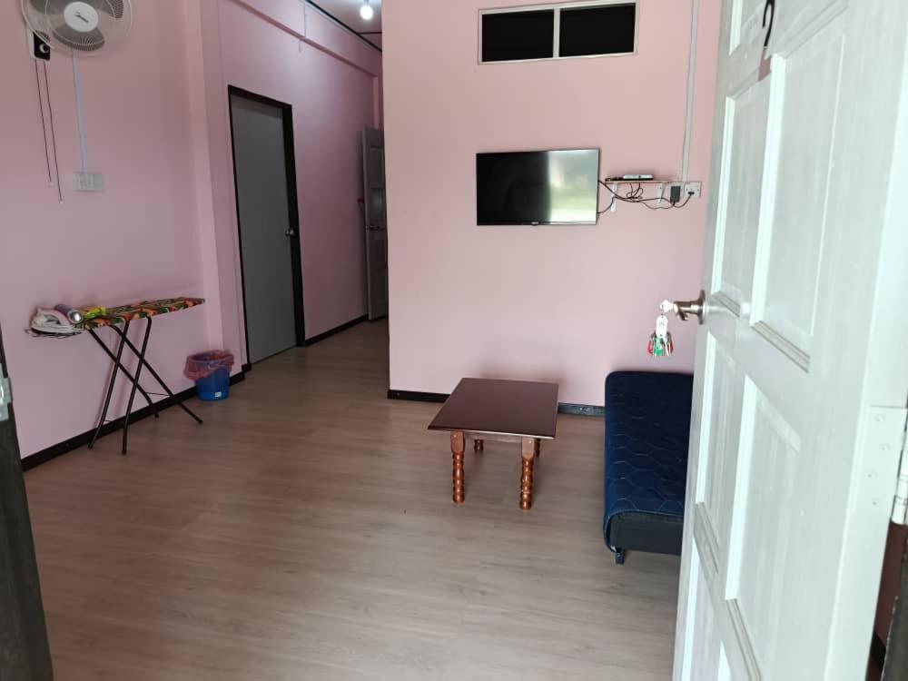 a hallway with a room with a table and a door at Dongorit Cabin 2 The three rooms in Kampong Kundassan
