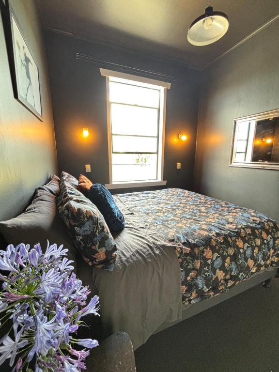 a bedroom with a bed and a window at Rehutai in Wairoa