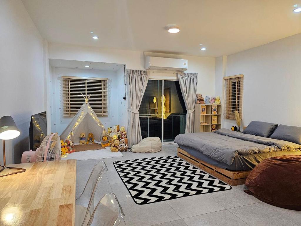 a bedroom with a bed and a crib in it at Tee Phak CNX Room D in Chiang Mai