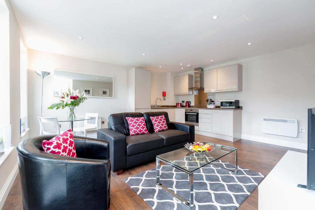 a living room with a couch and a table at Roomspace Serviced Apartments - Trinity House in Reigate