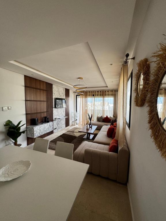 a large living room with a couch and a table at Murcia in Rabat