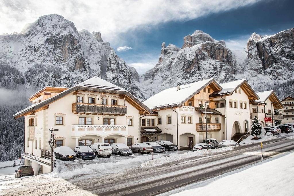 a hotel in the mountains with snow covered buildings at Residence Vila in Colfosco