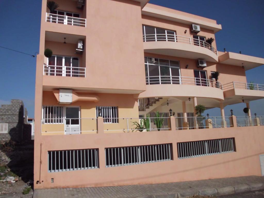 a building with balconies on the side of it at Restaurante Residencial Nova Cidade in Porto Novo