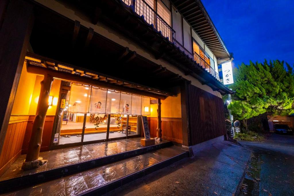 a building with a lit up window at night at Tsukasa Ryokan in Saga