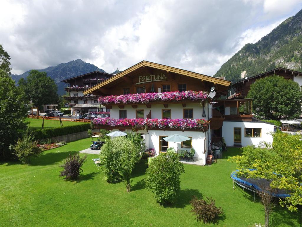 a building with flowers on the side of it at Appartements Fortuna in Pertisau